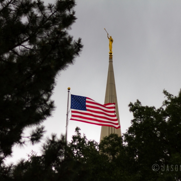 photo of the American flag flying on the Jordan River Utah Temple grounds